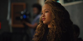 Movie still from “Stargirl” (2020), directed by Julia Hart – A woman with long curly brown hair looking to her left; Close Up shot, Over the shoulder angle