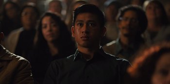 Movie still from “Stargirl” (2020), directed by Julia Hart – A group of people standing in a dark room; Close Up shot, Over the shoulder angle