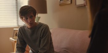 Movie still from “Stargirl” (2020), directed by Julia Hart – A man sitting on top of a couch in a living room; Close Up shot, Over the shoulder angle