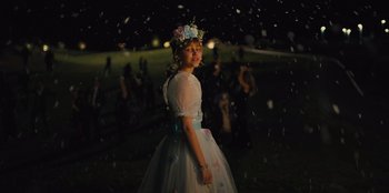Movie still from “Stargirl” (2020), directed by Julia Hart – A young girl in a white dress and a flower crown; Medium shot, Over the shoulder angle