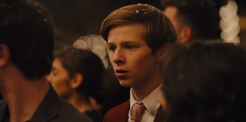 Movie still from “Stargirl” (2020), directed by Julia Hart – A man in a suit and tie in a crowd of people; Close Up shot, Over the shoulder angle