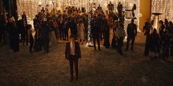 Movie still from “Stargirl” (2020), directed by Julia Hart – A crowd of people standing in a field at night; Wide shot, High angle