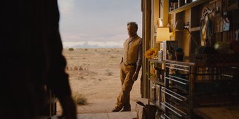 Movie still from “Stargirl” (2020), directed by Julia Hart – A man standing in front of an open door; Wide shot, Over the shoulder angle