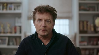 Movie still from “Still: A Michael J. Fox Movie” (2023), directed by Davis Guggenheim – A person wearing a black shirt; Close Up shot, Low angle