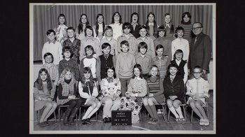 Movie still from “Still: A Michael J. Fox Movie” (2023), directed by Davis Guggenheim – An old photo of a group of people posing for a picture; Wide shot, Overhead angle
