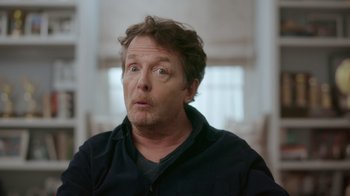 Movie still from “Still: A Michael J. Fox Movie” (2023), directed by Davis Guggenheim – A person wearing a black shirt; Close Up shot, Over the shoulder angle