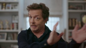 Movie still from “Still: A Michael J. Fox Movie” (2023), directed by Davis Guggenheim – A person talking to a camera; Close Up shot, Over the shoulder angle