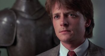 Movie still from “Still: A Michael J. Fox Movie” (2023), directed by Davis Guggenheim – A person wearing a suit and tie; Close Up shot, Low angle