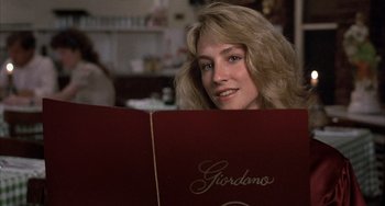 Movie still from “Still: A Michael J. Fox Movie” (2023), directed by Davis Guggenheim – A woman sitting in front of a red menu; Close Up shot, Over the shoulder angle