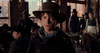 Movie still from “Still: A Michael J. Fox Movie” (2023), directed by Davis Guggenheim – A man wearing a cowboy hat and a scarf; Close Up shot, Low angle