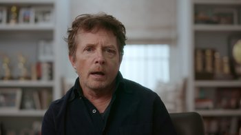 Movie still from “Still: A Michael J. Fox Movie” (2023), directed by Davis Guggenheim – A person wearing a black shirt; Close Up shot, Over the shoulder angle