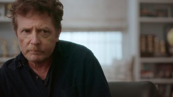 Movie still from “Still: A Michael J. Fox Movie” (2023), directed by Davis Guggenheim – A person wearing a black shirt; Close Up shot, Over the shoulder angle