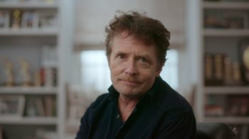 Movie still from “Still: A Michael J. Fox Movie” (2023), directed by Davis Guggenheim – A person wearing a black shirt; Close Up shot, Over the shoulder angle