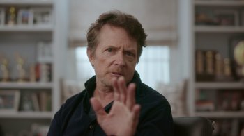 Movie still from “Still: A Michael J. Fox Movie” (2023), directed by Davis Guggenheim – A person sitting in a chair; Close Up shot, Over the shoulder angle