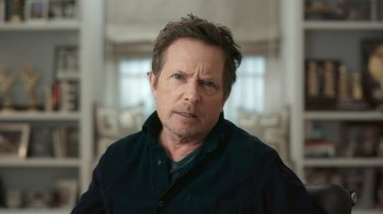 Movie still from “Still: A Michael J. Fox Movie” (2023), directed by Davis Guggenheim – A person wearing a black jacket; Close Up shot, Over the shoulder angle