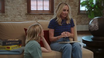 Movie still from “Still: A Michael J. Fox Movie” (2023), directed by Davis Guggenheim – A woman sitting on a couch talking to a young girl; Medium shot, Over the shoulder angle