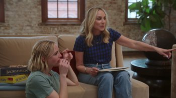 Movie still from “Still: A Michael J. Fox Movie” (2023), directed by Davis Guggenheim – A woman sitting on a couch next to another woman; Medium shot, Over the shoulder angle