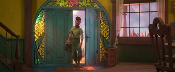 Movie still from “Strange World” (2022), directed by Don Hall – A man standing in front of an open door; Wide shot, Over the shoulder angle