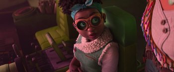 Movie still from “Strange World” (2022), directed by Don Hall – A girl with glasses is sitting in a chair; Close Up shot, Over the shoulder angle