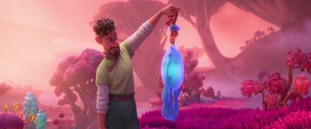Movie still from “Strange World” (2022), directed by Don Hall – A man holding a blue object in his hand; Medium shot, Over the shoulder angle