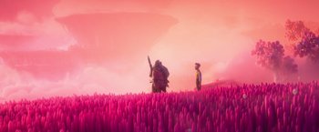 Movie still from “Strange World” (2022), directed by Don Hall – Two people standing in a field of pink flowers; Extreme Wide shot, High angle