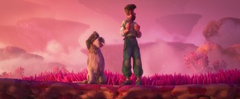 Movie still from “Strange World” (2022), directed by Don Hall – A man and a dog standing next to each other; Wide shot, High angle