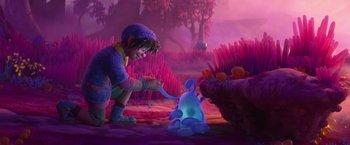 Movie still from “Strange World” (2022), directed by Don Hall – An animated scene of a boy playing with an object; Wide shot, Over the shoulder angle