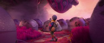 Movie still from “Strange World” (2022), directed by Don Hall – A person with a backpack walking through a field of flowers; Wide shot, Overhead angle