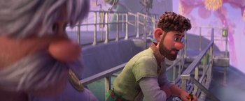 Movie still from “Strange World” (2022), directed by Don Hall – A man in a green shirt is sitting down; Medium shot, Over the shoulder angle