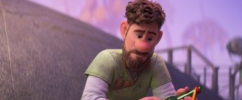 Movie still from “Strange World” (2022), directed by Don Hall – An animated man with a beard is looking at a book; Close Up shot, Over the shoulder angle