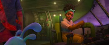 Movie still from “Strange World” (2022), directed by Don Hall – A little girl sitting in a chair in front of some bubbles; Medium shot, Over the shoulder angle