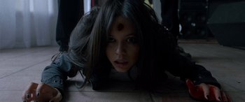 Movie still from “Studio 666” (2022), directed by BJ McDonnell – A woman with a red spot on her forehead; Close Up shot, High angle