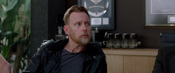 Movie still from “Studio 666” (2022), directed by BJ McDonnell – A person sitting in a room; Close Up shot, Over the shoulder angle