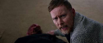 Movie still from “Studio 666” (2022), directed by BJ McDonnell – A person standing over another person; Close Up shot, Over the shoulder angle