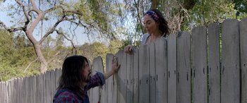 Movie still from “Studio 666” (2022), directed by BJ McDonnell – A man and a woman standing next to a fence; Medium shot, Over the shoulder angle