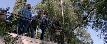 Movie still from “Studio 666” (2022), directed by BJ McDonnell – A group of men standing on top of a balcony; Wide shot, Low angle