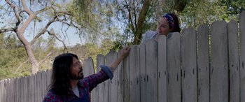 Movie still from “Studio 666” (2022), directed by BJ McDonnell – A man and a woman standing next to a fence; Medium shot, Over the shoulder angle
