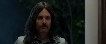 Movie still from “Studio 666” (2022), directed by BJ McDonnell – A person with long black hair; Close Up shot, Over the shoulder angle