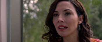 Movie still from “Studio 666” (2022), directed by BJ McDonnell – A woman's face in front of trees; Close Up shot, Over the shoulder angle