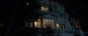 Movie still from “Studio 666” (2022), directed by BJ McDonnell – A building that has been lit up at night time; Extreme Wide shot, Low angle