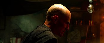 Movie still from “Studio 666” (2022), directed by BJ McDonnell – A man with a bald head is looking to his left; Close Up shot, Over the shoulder angle