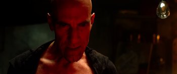 Movie still from “Studio 666” (2022), directed by BJ McDonnell – A man with a shaved head is looking at the camera; Close Up shot, Low angle