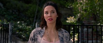 Movie still from “Studio 666” (2022), directed by BJ McDonnell – A person wearing a necklace; Close Up shot, Over the shoulder angle