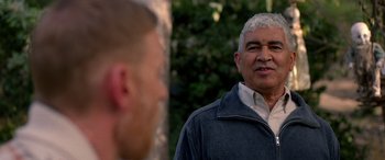 Movie still from “Studio 666” (2022), directed by BJ McDonnell – A man standing next to another man in front of a tree; Close Up shot, Over the shoulder angle