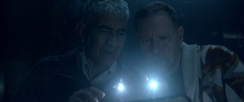 Movie still from “Studio 666” (2022), directed by BJ McDonnell – Two men are looking at something in the dark; Close Up shot, Low angle