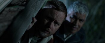 Movie still from “Studio 666” (2022), directed by BJ McDonnell – A man and a woman standing next to each other in the dark; Close Up shot, Low angle