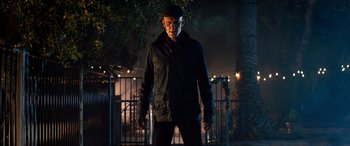 Movie still from “Studio 666” (2022), directed by BJ McDonnell – A man in a black jacket standing in front of a fence; Medium shot, Low angle
