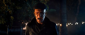 Movie still from “Studio 666” (2022), directed by BJ McDonnell – An old man with a black hat and a black jacket; Close Up shot, Low angle