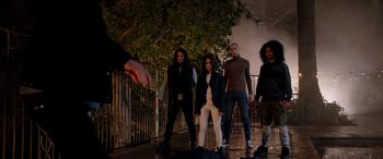 Movie still from “Studio 666” (2022), directed by BJ McDonnell – A group of people standing next to each other on a sidewalk; Wide shot, High angle