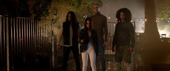 Movie still from “Studio 666” (2022), directed by BJ McDonnell – A group of people standing next to each other on a sidewalk; Wide shot, Low angle